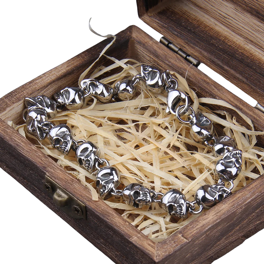 Silver bracelet with leaf designs in a wooden box with straw-like filler