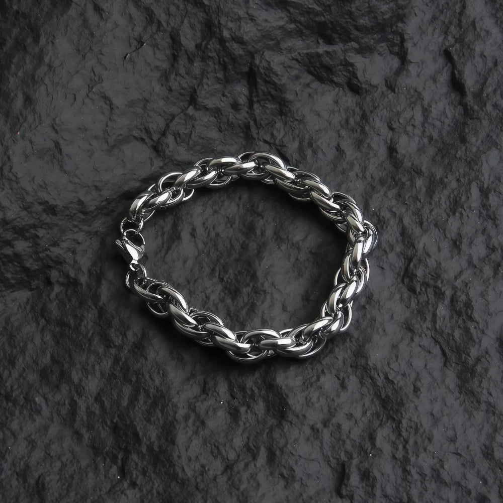 Silver braided ring on a dark stone surface